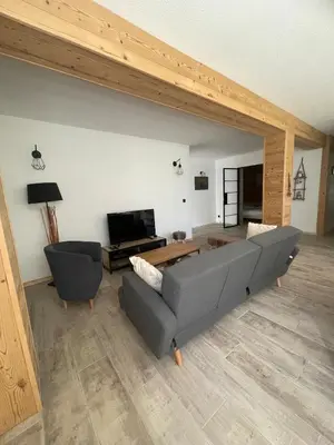 a living room with a couch and a table at Cozy & modern apartment in Samoëns