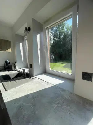 an empty room with a large window in a house at Cozy & modern apartment in Samoëns
