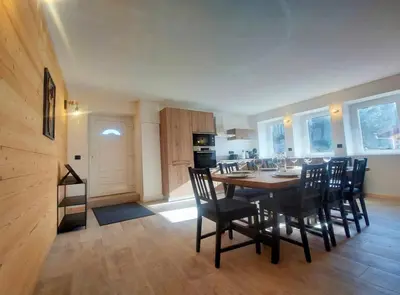 a kitchen and dining room with a table and chairs at Cozy & modern apartment in Samoëns