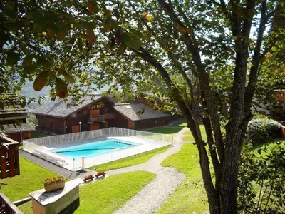 a house with a swimming pool in a yard at Cosy alpine apartment with pool and stunning views in Saint-Gervais-les-Bains