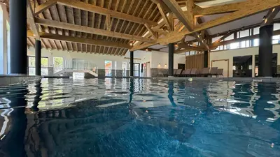 a swimming pool with blue water in a building at Luxury Penthouse With Mont Blanc Views In Megève in Megève