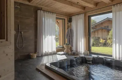 a bathroom with a bath tub with a large window at Luxury Alpine Chalet In Samoëns in Samoëns