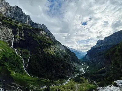 a mountain valley with a river flowing through it at Chalet des Cimes in Samoëns