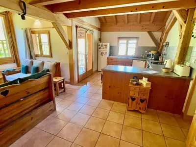 a large kitchen with a counter in a room at Chalet des Cimes in Samoëns