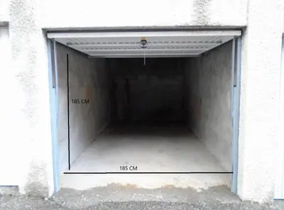 a garage with a door in the side of a building at Grand Studio 25 m2, lumineux, central, vue Mont-Blanc in Chamonix-Mont-Blanc