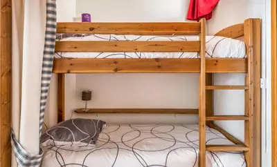 a bunk bed in a room with a ladder at Grand Studio 25 m2, lumineux, central, vue Mont-Blanc in Chamonix-Mont-Blanc