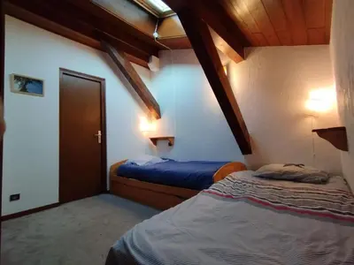 a bedroom with two beds in a room at Duplex Saint Gervais in Saint-Gervais-les-Bains