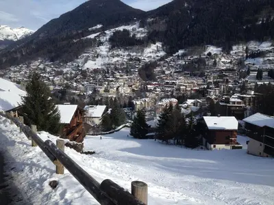 a town in the snow with a mountain at Duplex Saint Gervais in Saint-Gervais-les-Bains