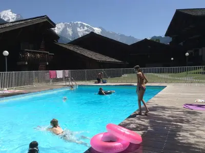 a group of people in a swimming pool with pink frisbees at Duplex Saint Gervais in Saint-Gervais-les-Bains
