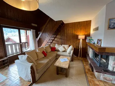 a living room with a couch and a fireplace at Duplex Saint Gervais in Saint-Gervais-les-Bains