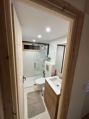 a bathroom with a toilet and a sink and a mirror at Face au MtBlanc avec jardin in Les Houches