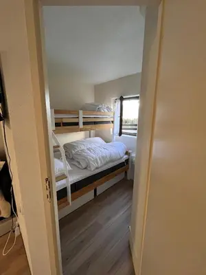 a small room with a bunk bed and a window at Le LODGE Les Esserts 1100 Morillon in Morillon