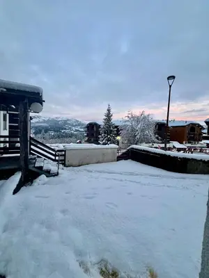 a yard covered in snow next to a house at Le LODGE Les Esserts 1100 Morillon in Morillon