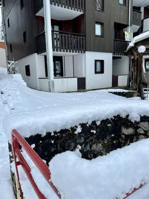 a pile of snow in front of a building at Le LODGE Les Esserts 1100 Morillon in Morillon