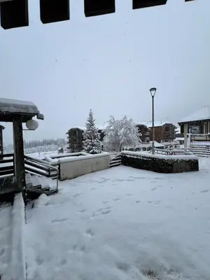 a yard covered in snow with a street light at Le LODGE Les Esserts 1100 Morillon in Morillon