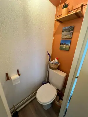 a bathroom with a white toilet in a room at Le LODGE Les Esserts 1100 Morillon in Morillon