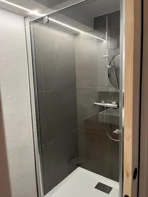 a shower with a glass door in a bathroom at Ambiance alpine in Sallanches
