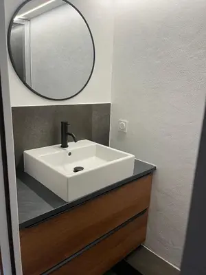 a bathroom with a white sink and a mirror at Ambiance alpine in Sallanches