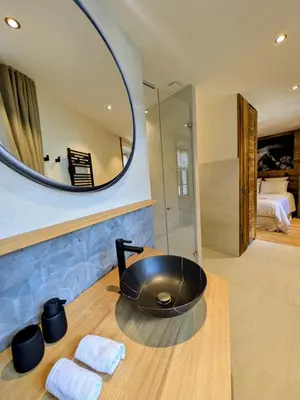 a bathroom with a black sink and a mirror at Appartement Nuage, Luxe, centre village Megève in Megève