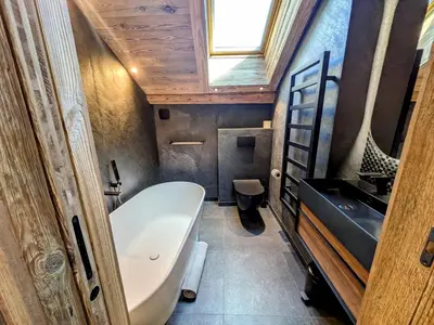 a bathroom with a white tub and a sink at Appartement Nuage, Luxe, centre village Megève in Megève