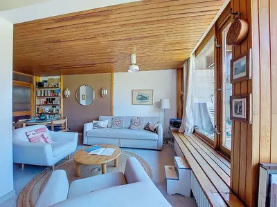 a living room with white furniture and a wooden ceiling at Apartment Résidence Les Tines by Interhome in Chamonix-Mont-Blanc