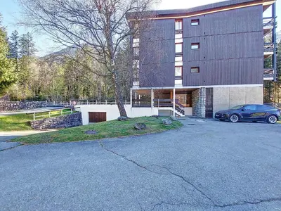 a car parked in a parking lot in front of a building at Apartment Résidence Les Tines by Interhome in Chamonix-Mont-Blanc