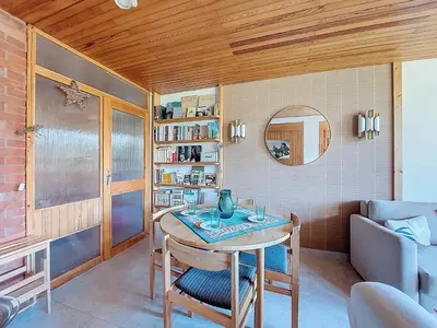 a room with a table and a chair and a mirror at Apartment Résidence Les Tines by Interhome in Chamonix-Mont-Blanc
