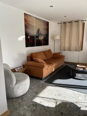 a living room with a couch and a table at Huxa Appt Megève Centre in Megève