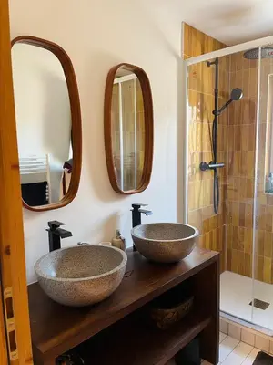 two sinks in a bathroom with two mirrors at Huxa Appt Megève Centre in Megève