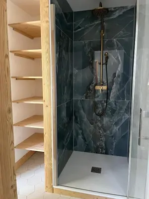 a shower with a glass door in a bathroom at Huxa Appt Megève Centre in Megève
