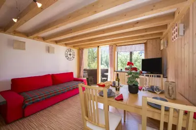 a table and chairs on a balcony with a mountain at Résidence Grand Roc - Campanules 112 - Happy Rentals in Chamonix-Mont-Blanc