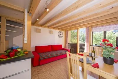 a bathroom with a sink and a tub and a mirror at Résidence Grand Roc - Campanules 112 - Happy Rentals in Chamonix-Mont-Blanc