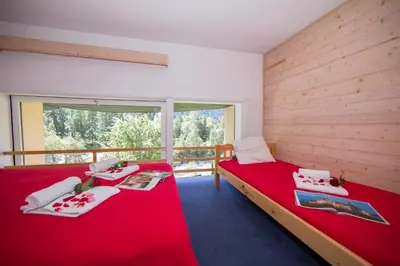a bedroom with two bunk beds and a hallway at Résidence Grand Roc - Campanules 112 - Happy Rentals in Chamonix-Mont-Blanc