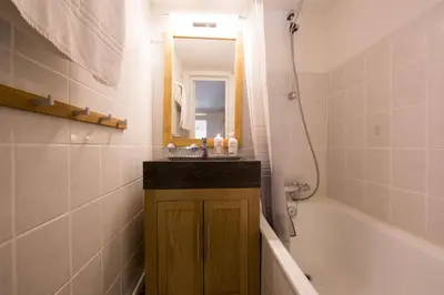 a bedroom with two bunk beds and a mirror at Résidence Grand Roc - Campanules 112 - Happy Rentals in Chamonix-Mont-Blanc
