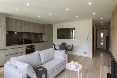 a living room with a couch and a kitchen at Cristal des Glaces 3 - Proche lac - Vues in Chamonix-Mont-Blanc