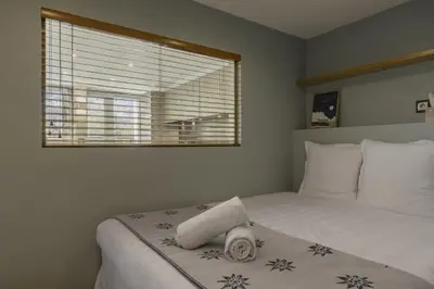a bedroom with a white bed with a window at Cristal des Glaces 3 - Proche lac - Vues in Chamonix-Mont-Blanc