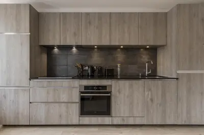 a kitchen with wooden cabinets and a sink at Cristal des Glaces 3 - Proche lac - Vues in Chamonix-Mont-Blanc