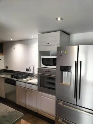 a kitchen with a stainless steel refrigerator and a microwave at Chalet Peppa in Sallanches