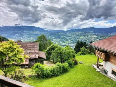 an image of a house with mountains in the background at Chalet Peppa in Sallanches