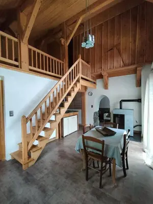 a dining room with a table and a staircase at Chalet Peppa in Sallanches