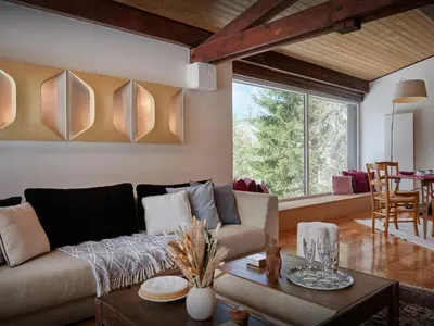 a living room with a couch and a table at Chalet Jorat - OVO Network in Les Contamines-Montjoie