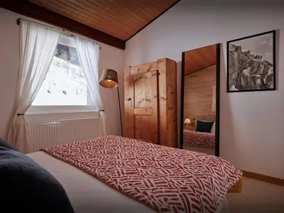 a bedroom with a bed and a window at Chalet Jorat - OVO Network in Les Contamines-Montjoie