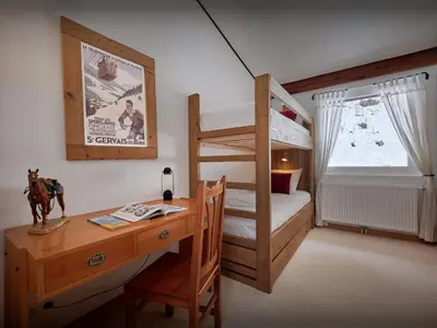 a bedroom with a desk and a bunk bed at Chalet Jorat - OVO Network in Les Contamines-Montjoie