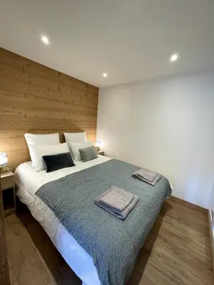 a bedroom with a large bed with two towels on it at NEW Lac Chavants apartment - 4 beds in Les Houches