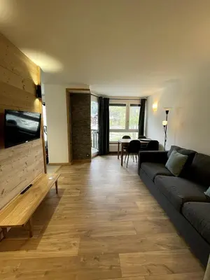 a living room with a couch and a table at NEW Lac Chavants apartment - 4 beds in Les Houches