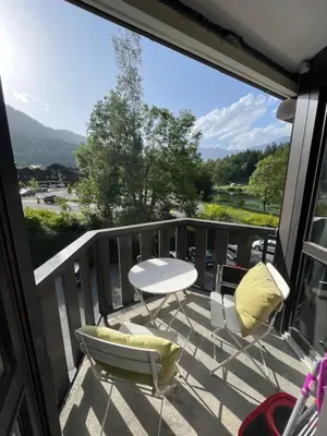 a balcony with a table and chairs and a view at NEW Lac Chavants apartment - 4 beds in Les Houches