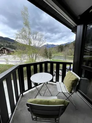 a patio with a table and chairs on a balcony at NEW Lac Chavants apartment - 4 beds in Les Houches