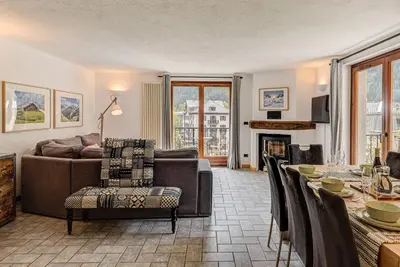 a living room with a couch and a table at Apartment Winn, Alpes Travel, Central Chamonix, Sleeps 6 in Chamonix-Mont-Blanc