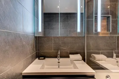 a bathroom with a sink and a mirror at Apartment Winn, Alpes Travel, Central Chamonix, Sleeps 6 in Chamonix-Mont-Blanc