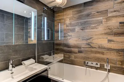 a bathroom with a tub and a sink at Apartment Winn, Alpes Travel, Central Chamonix, Sleeps 6 in Chamonix-Mont-Blanc